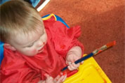 Baby in Painting Tiny Tots Room at Wombles Crèche